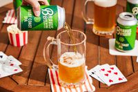 a hand pouring bravus west coast ipa into a glass