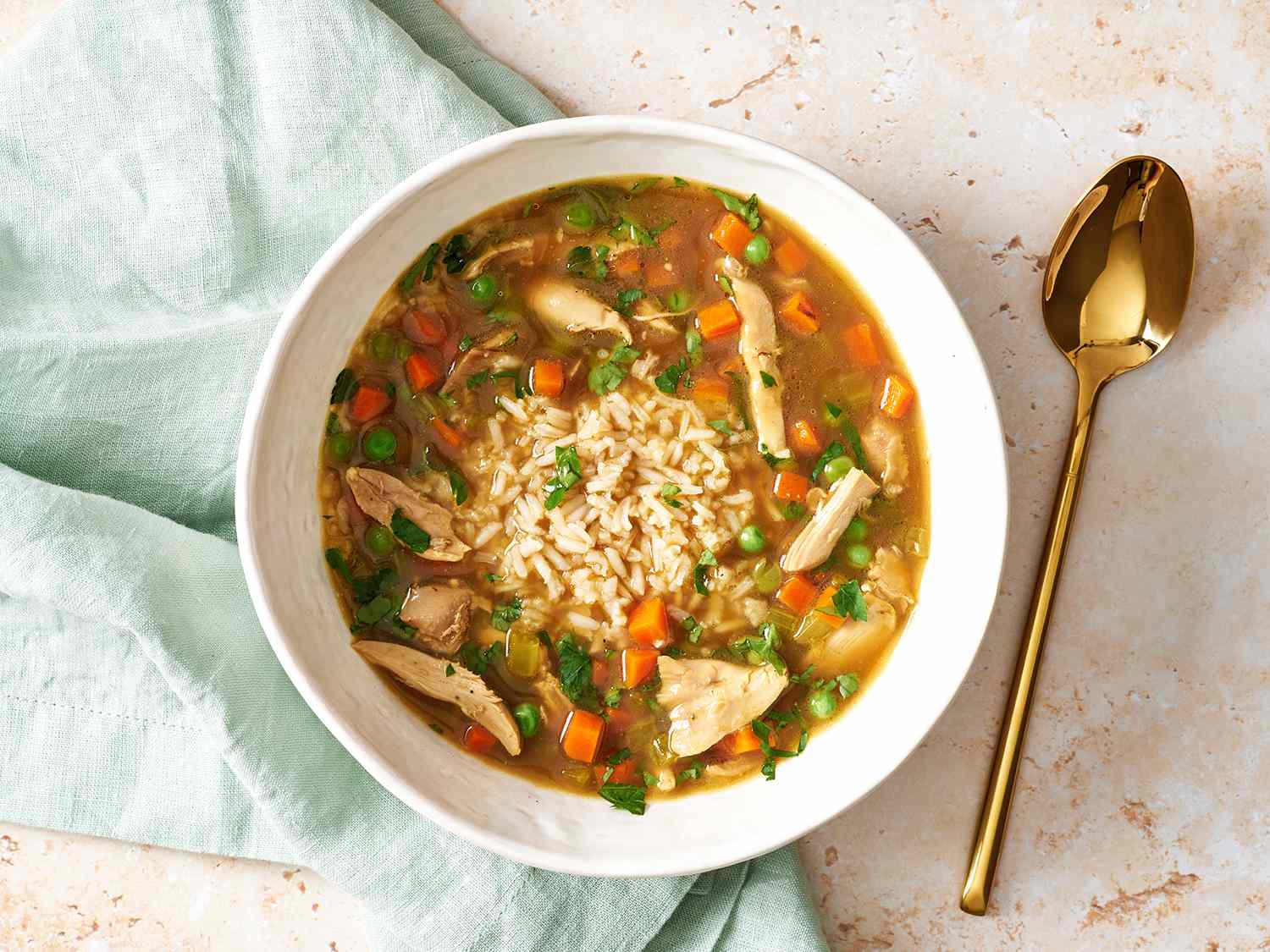 Chicken & rice soup in a white bowl.