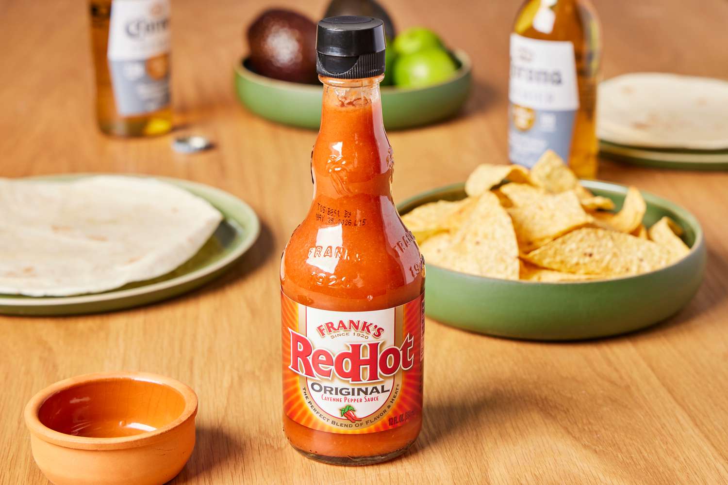 Frank's RedHot Original Cayenne Pepper Sauce ontable with chips