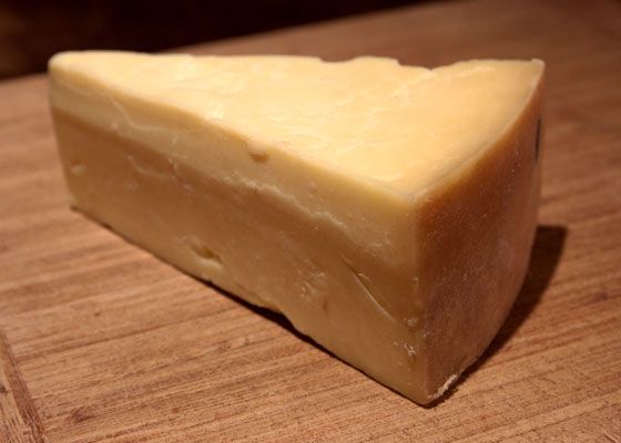 A wedge of Cheddar cheese