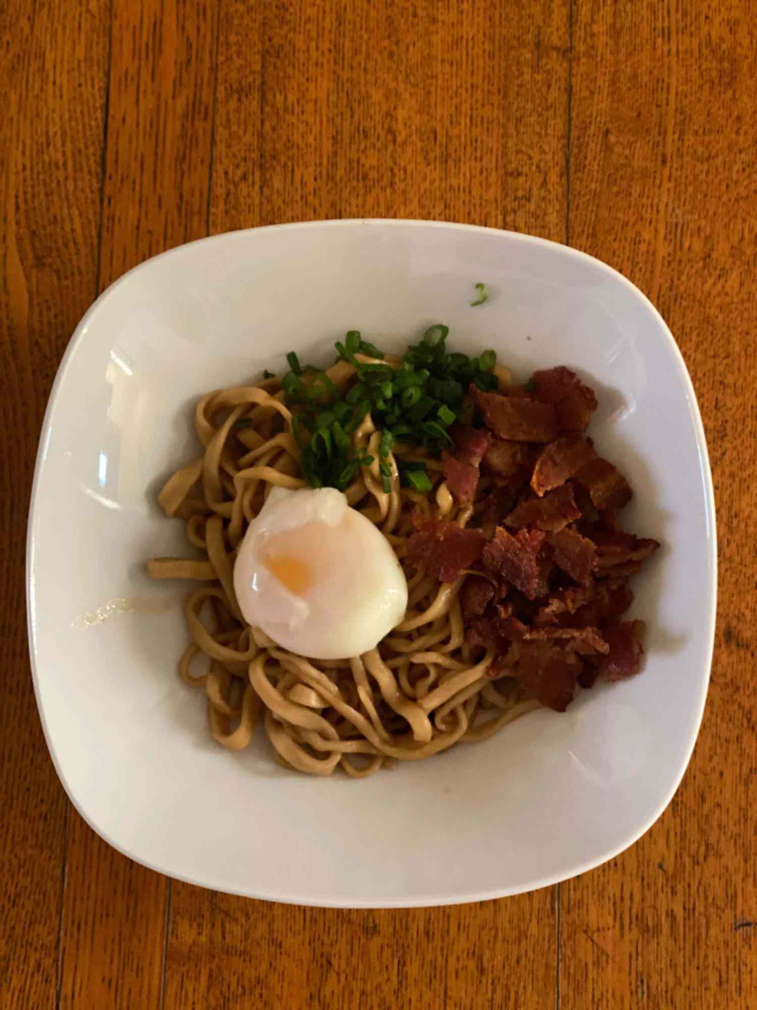 Overhead view of bowl of bacon and egg mazemen