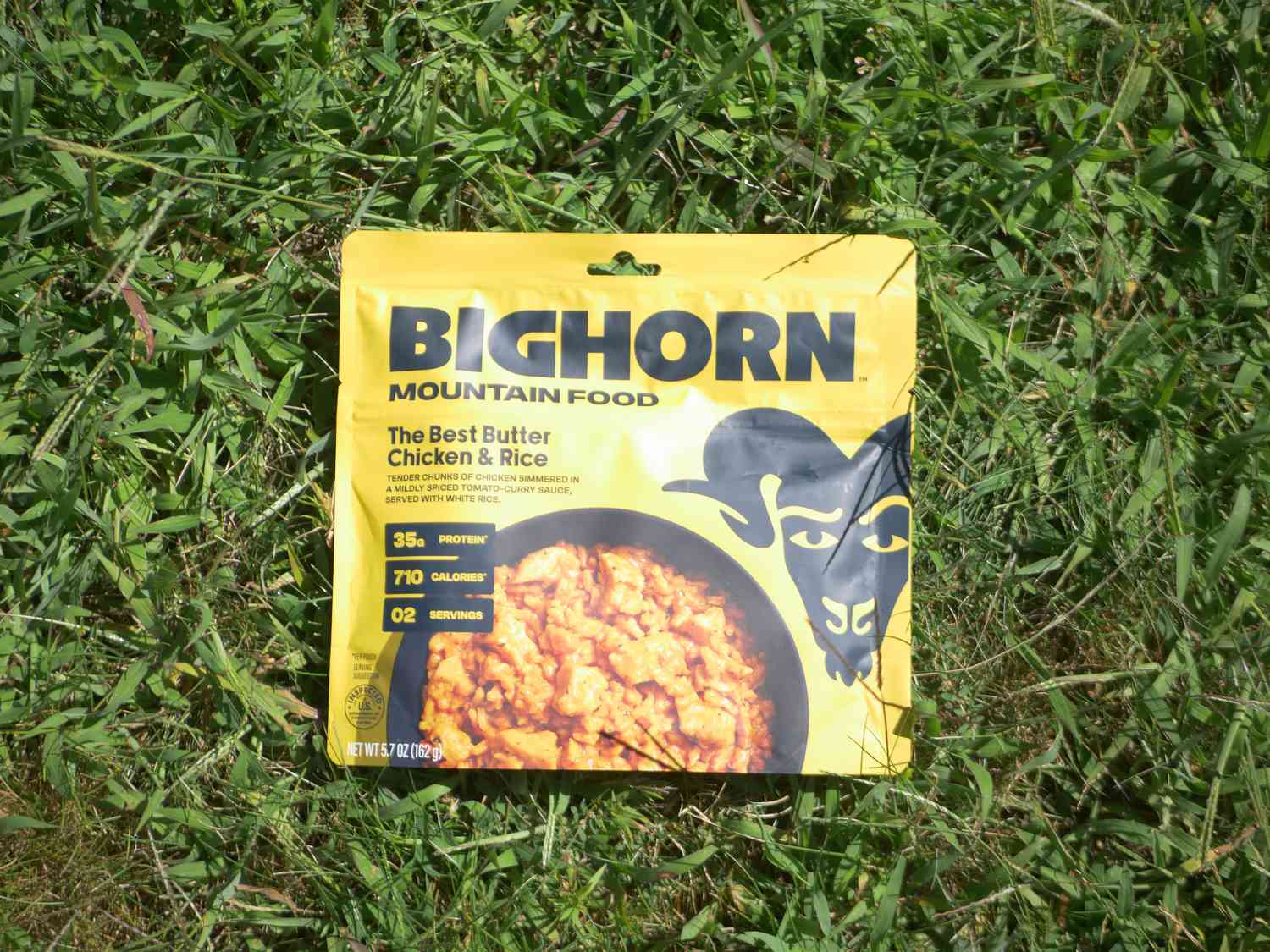 bighorn butter chicken and rice on a grassy surface