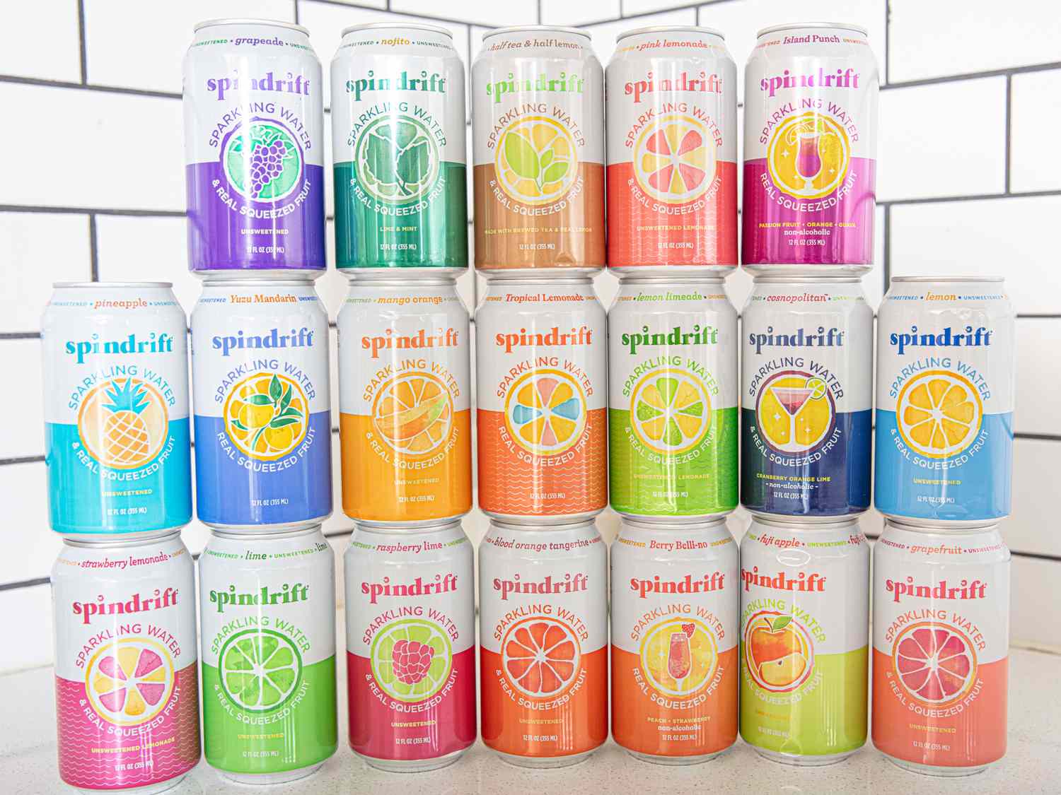 A display of stacked Spindrift sparkling water cans in various flavors organized in a grid