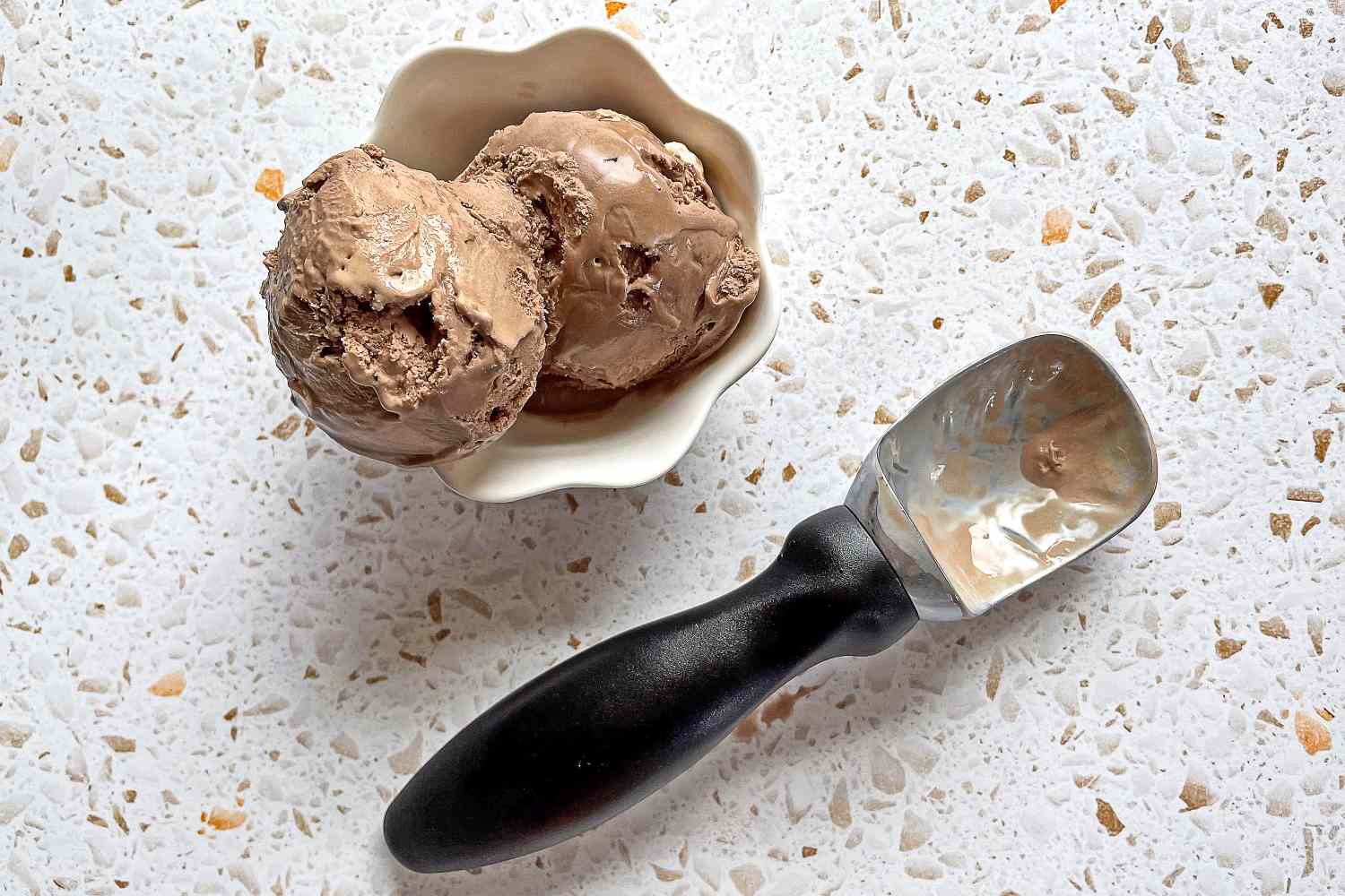 the gorilla grip ice cream scoop with two scoops of chocolate ice cream
