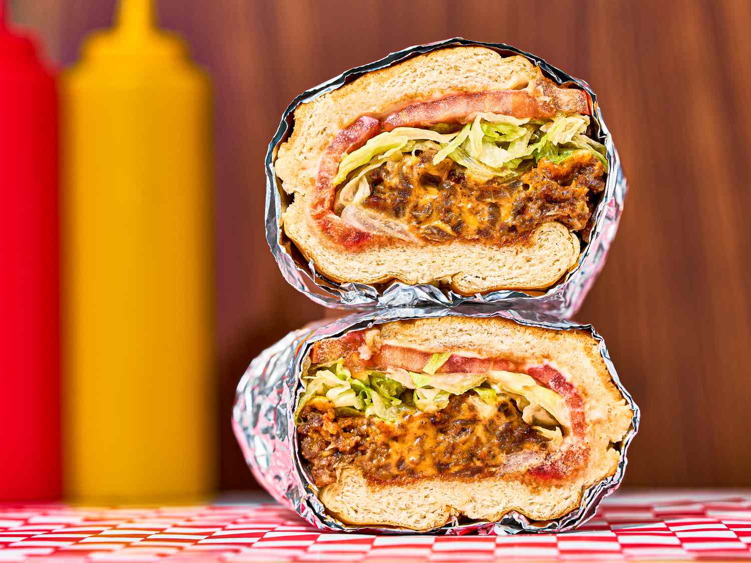 Chopped cheese sandwich stacked on top of one another.