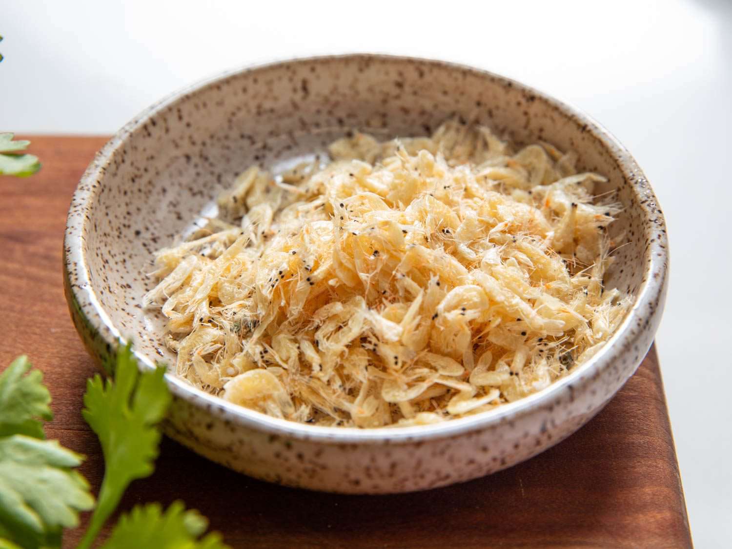 An earthenware pinch bowl of small "shrimp skin" dried shrimp.