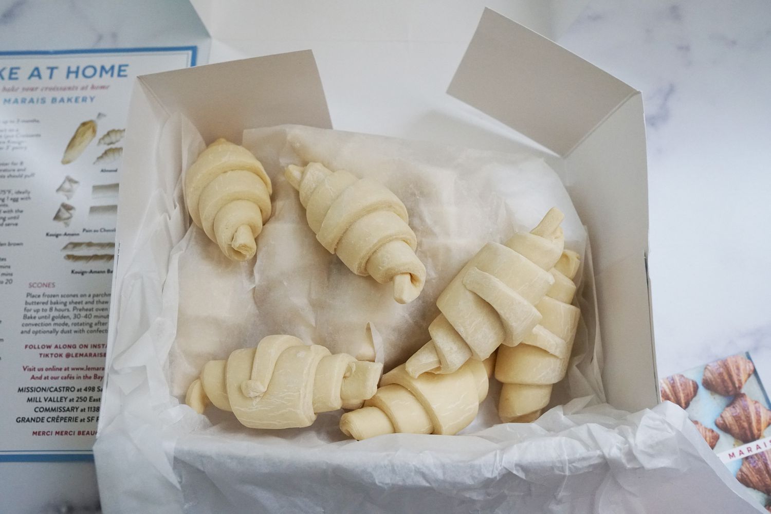 a box of frozen croissants on a marble surface