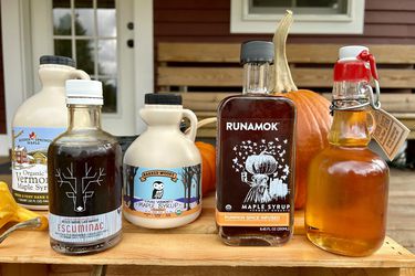 A collection of maple syrup bottles on a crate