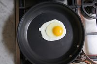 An egg frying in the Le Creuset Ceramic Nonstick Frying Pan