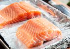 Salmon on a foil-lined sheet tray.