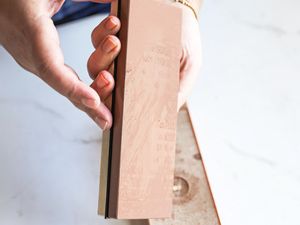 A person holding the King Whetstone sharpening set