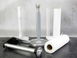 Paper towel holders on a gray and black backdrop