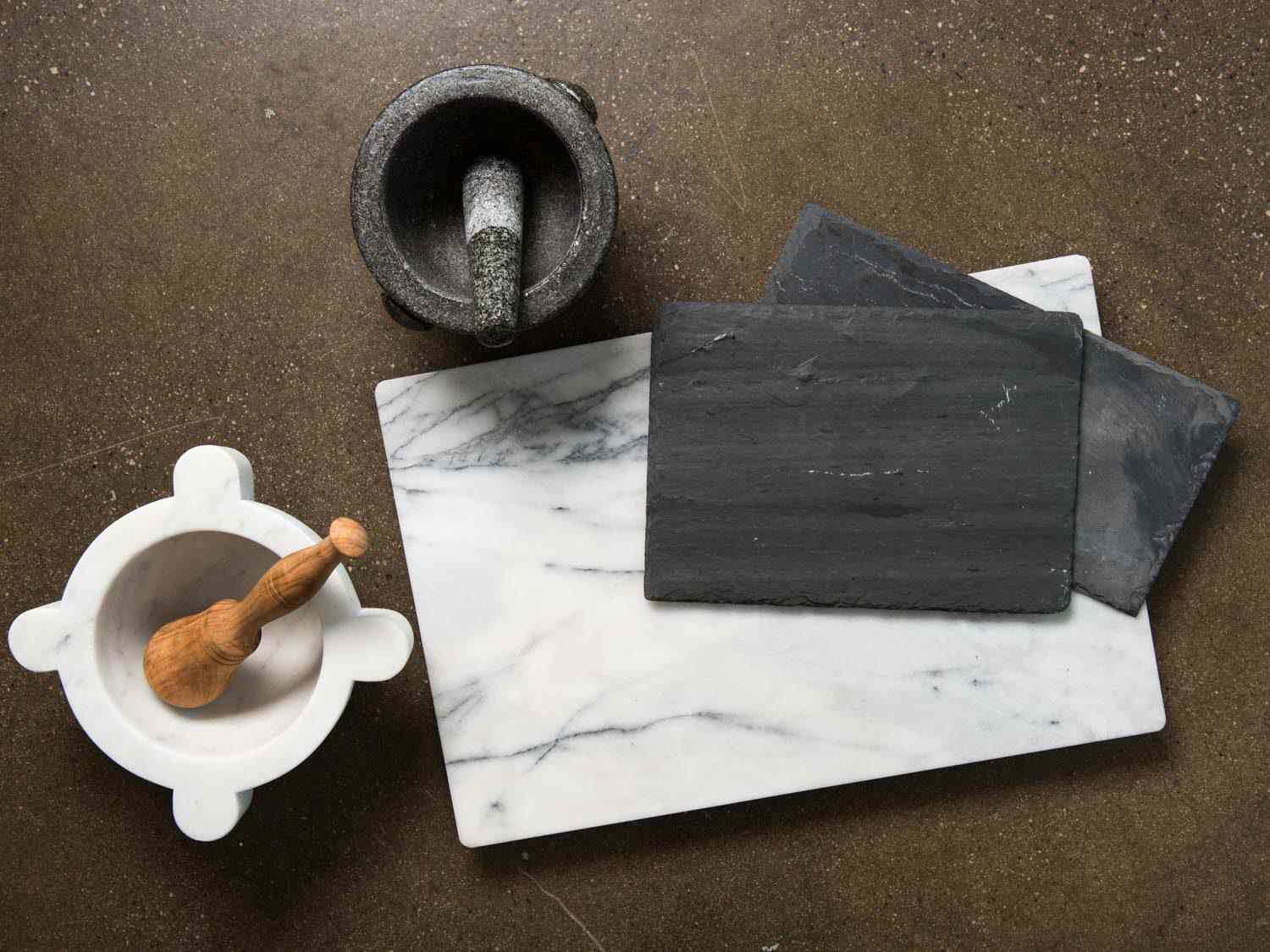 Marble and granite mortars and pestles, plus marble and slate work and serving surfaces.