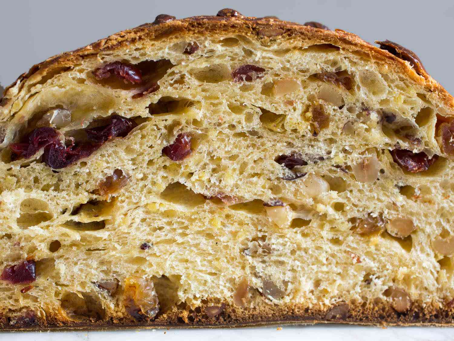 Cross section view of panettone full of dried cherries and toasted hazelnut
