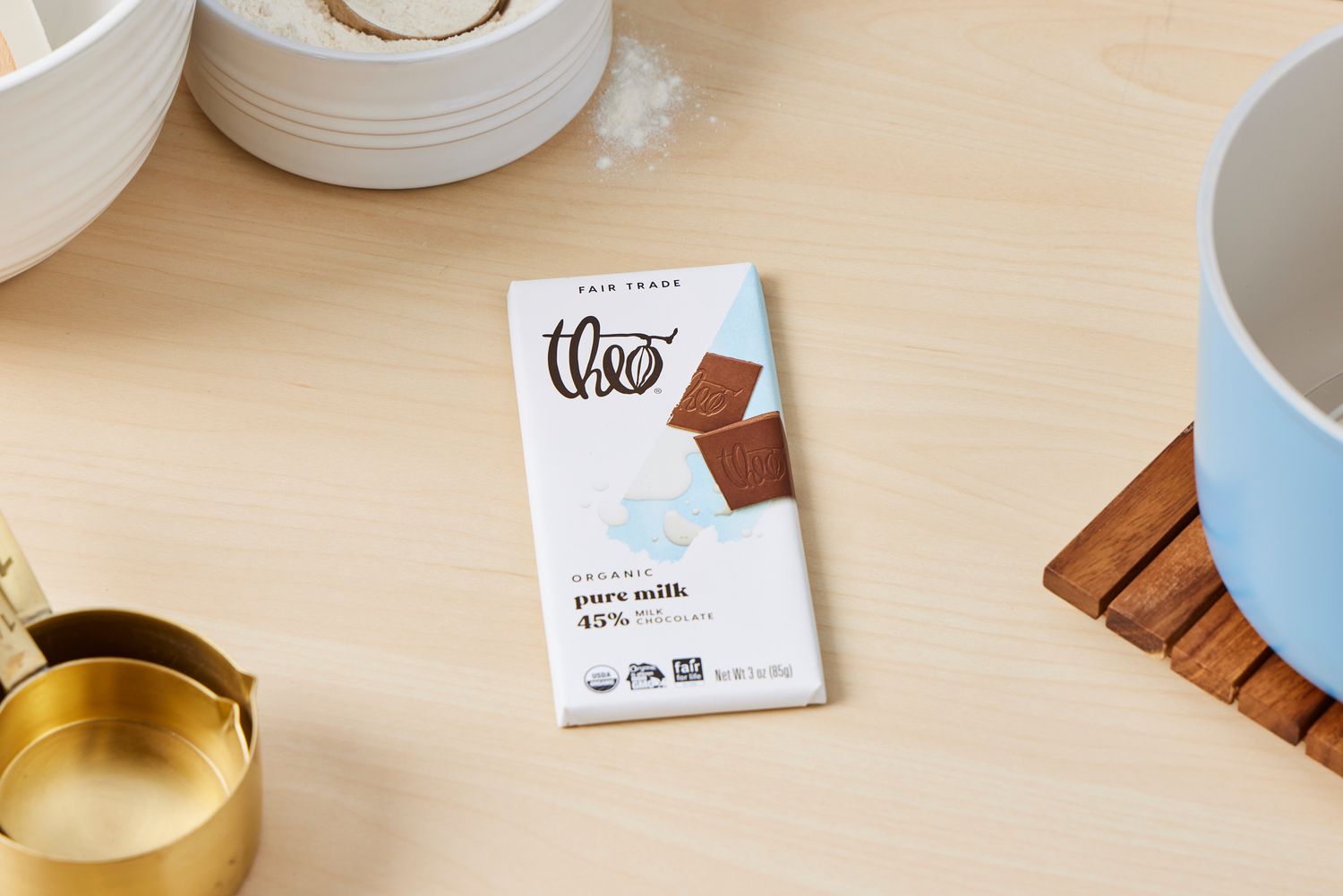 A Theo's milk chocolate bar on a kitchen countertop.