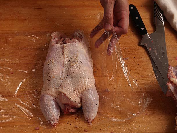 Wrapping stuffed whole deboned chicken in plastic wrap