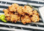 Savory fritters served with herbs and peppers.