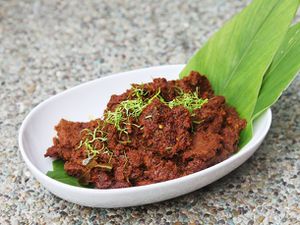 Beef rendang in an oval white bowl 