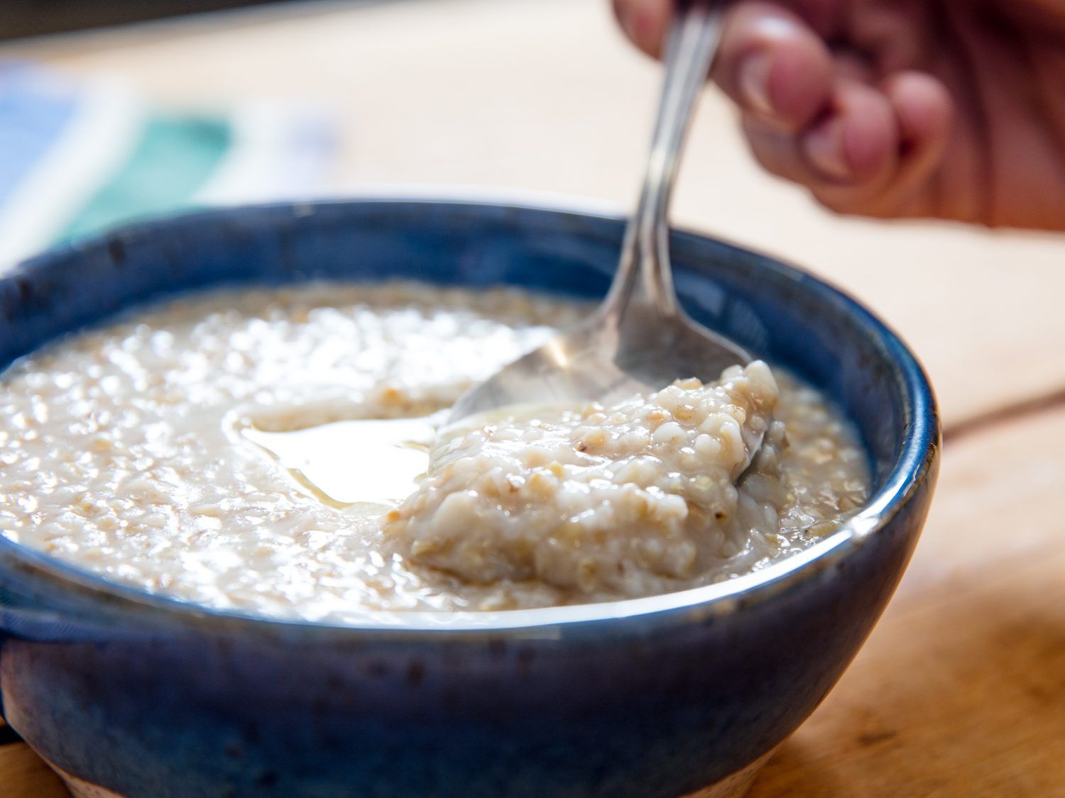 A spoonful of Scottish oatmeal with butter in a bowl.