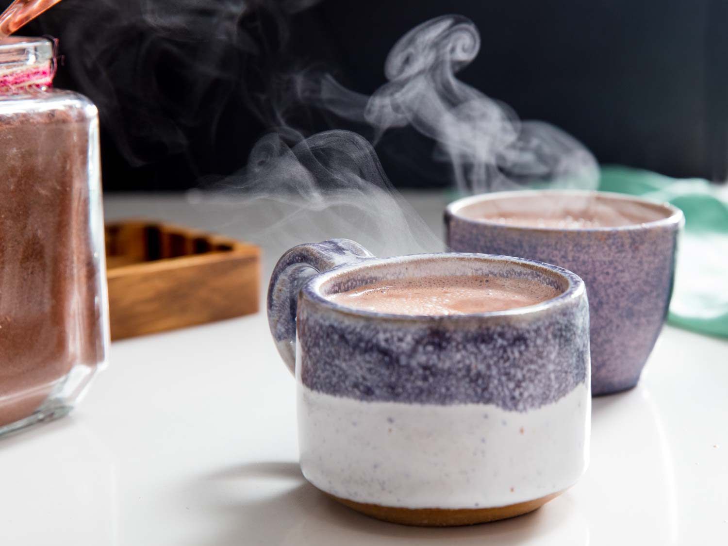 steaming mugs of hot cocoa