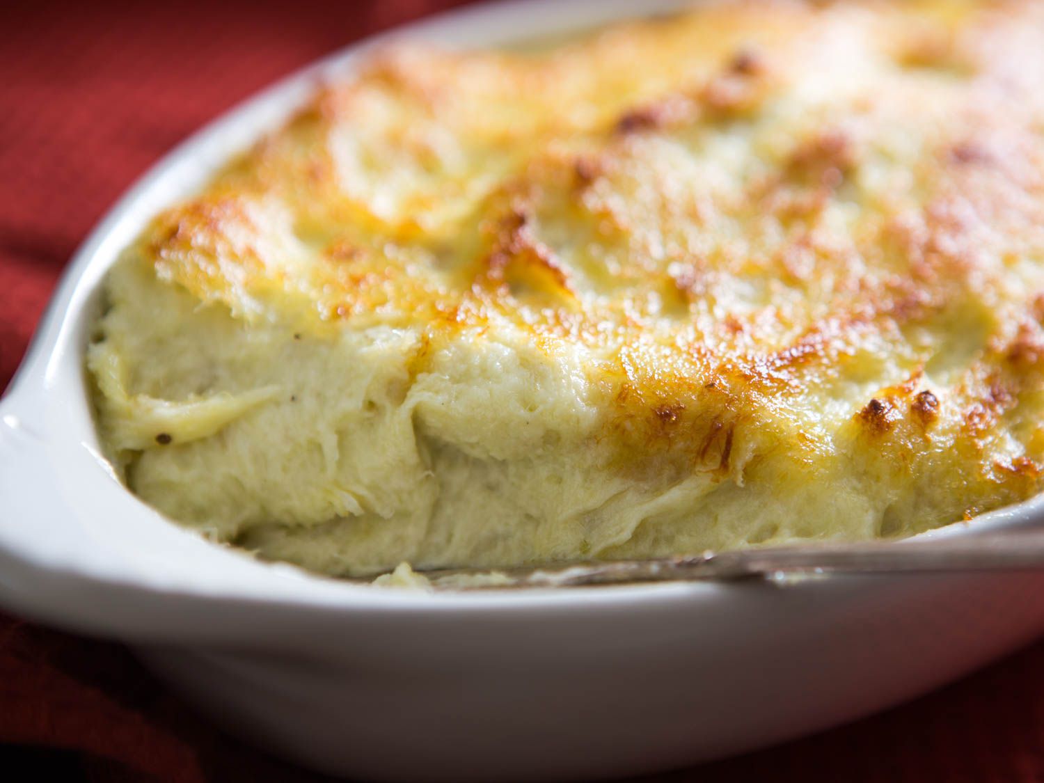 The brandade in a ceramic baking dish after broiling.