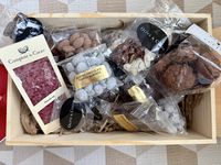 Assorted chocolate goodies arranged in a wooden crate