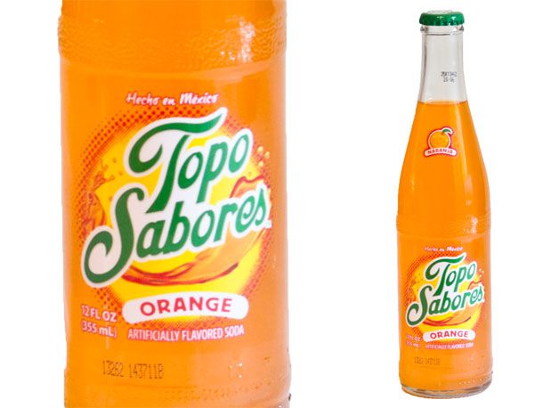 Closeup of a bottle of Topo Sabores orange soda.