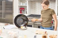 An egg is fried in the Yosukata Carbon Steel Wok Pan