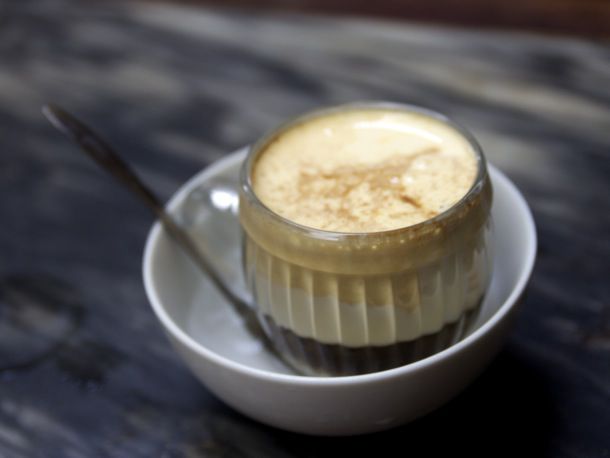 A small glass jar holding ca phe (Coffee)