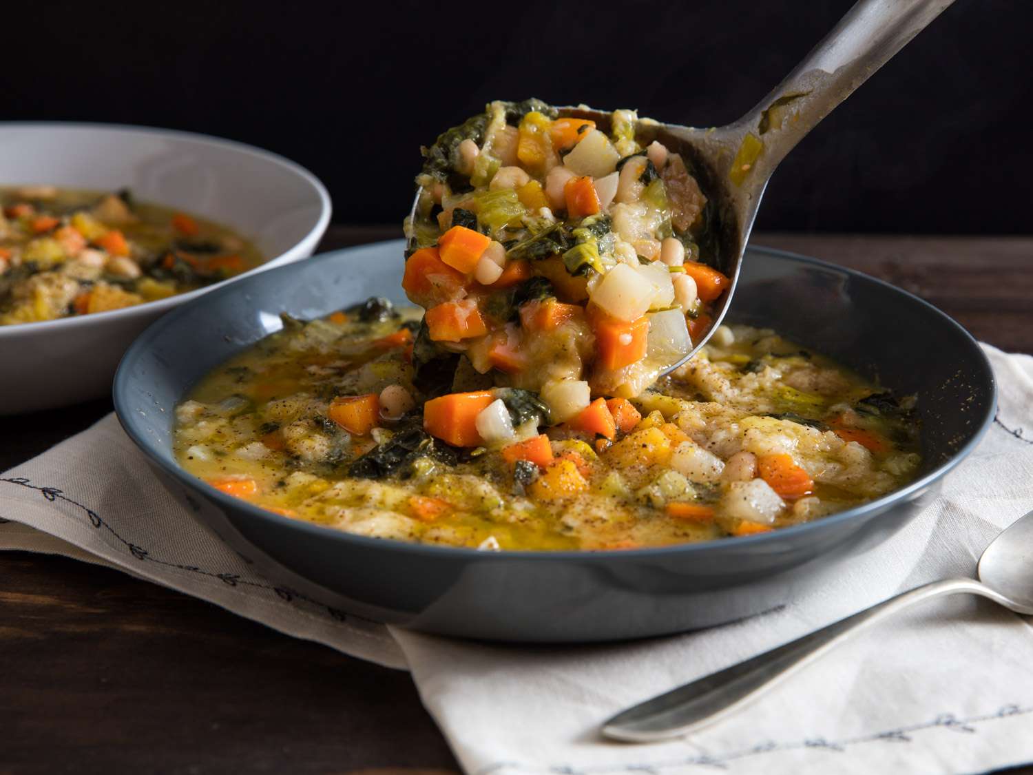 The finished ribollita is ladled into serving bowls.