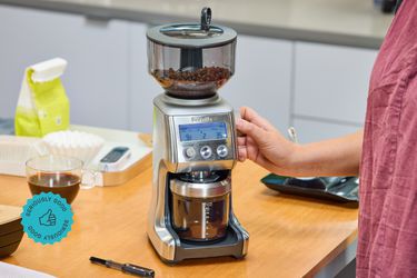 A person adjusting the dial of the Breville Smart Grinder Pro.