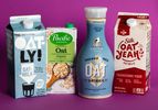 Four cartons of oatmilk from different brands.