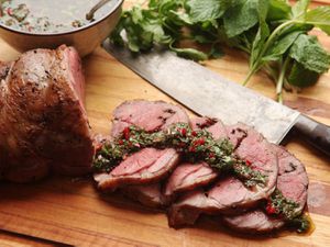 Sous vide lamb leg sliced up topped with chimichurri sauce 