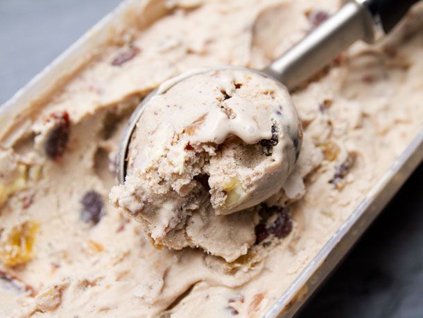 Scooping fruitcake ice cream with an ice cream scoop. 