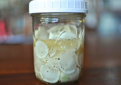 A pint jar of pickled hakurei turnips, ready to eat.