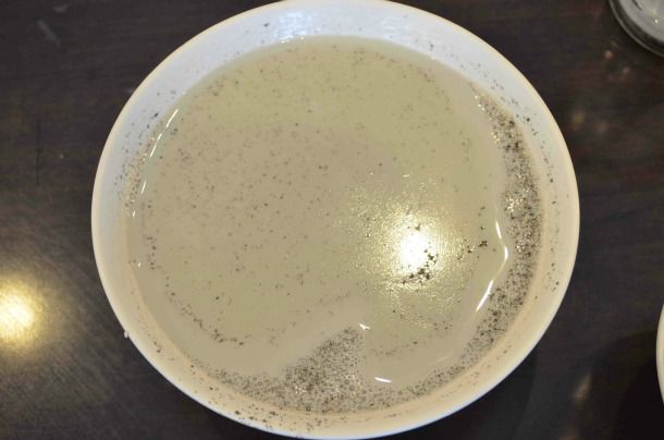 Closeup of black soybean milk, served in a bowl.