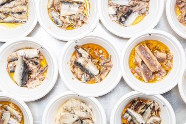 Multiple bowls containing tinned sardines shown in various presentations