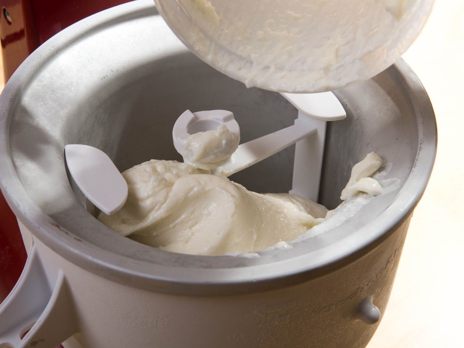 Transferring partially thawed soft-serve ice cream into an ice cream freezing core to re-churn.