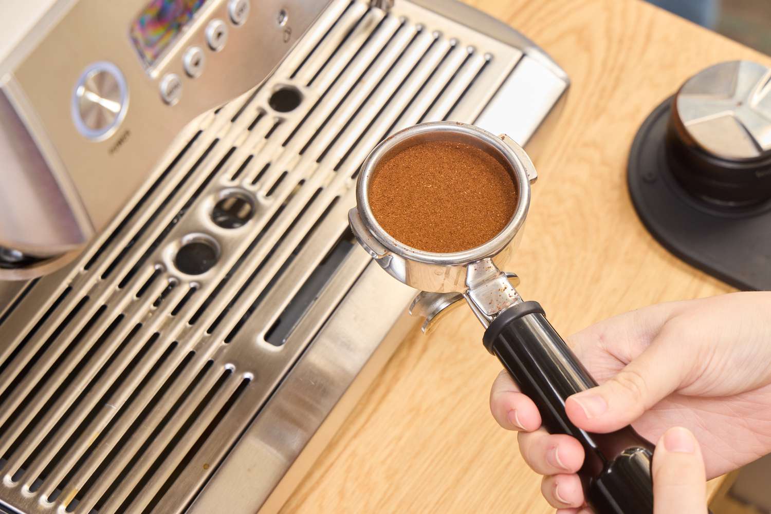 Espresso beans are loaded into the Breville BES920XL Dual Boiler Espresso Machine