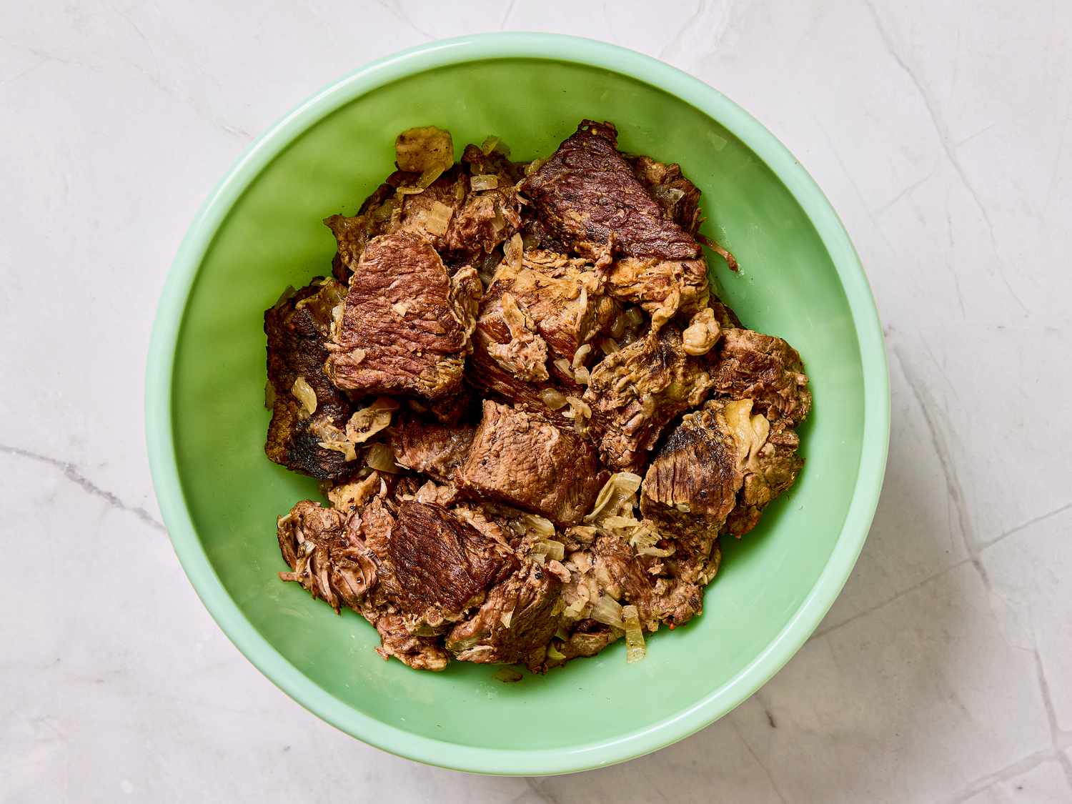 A bowl of beef stroganoff served in a green container