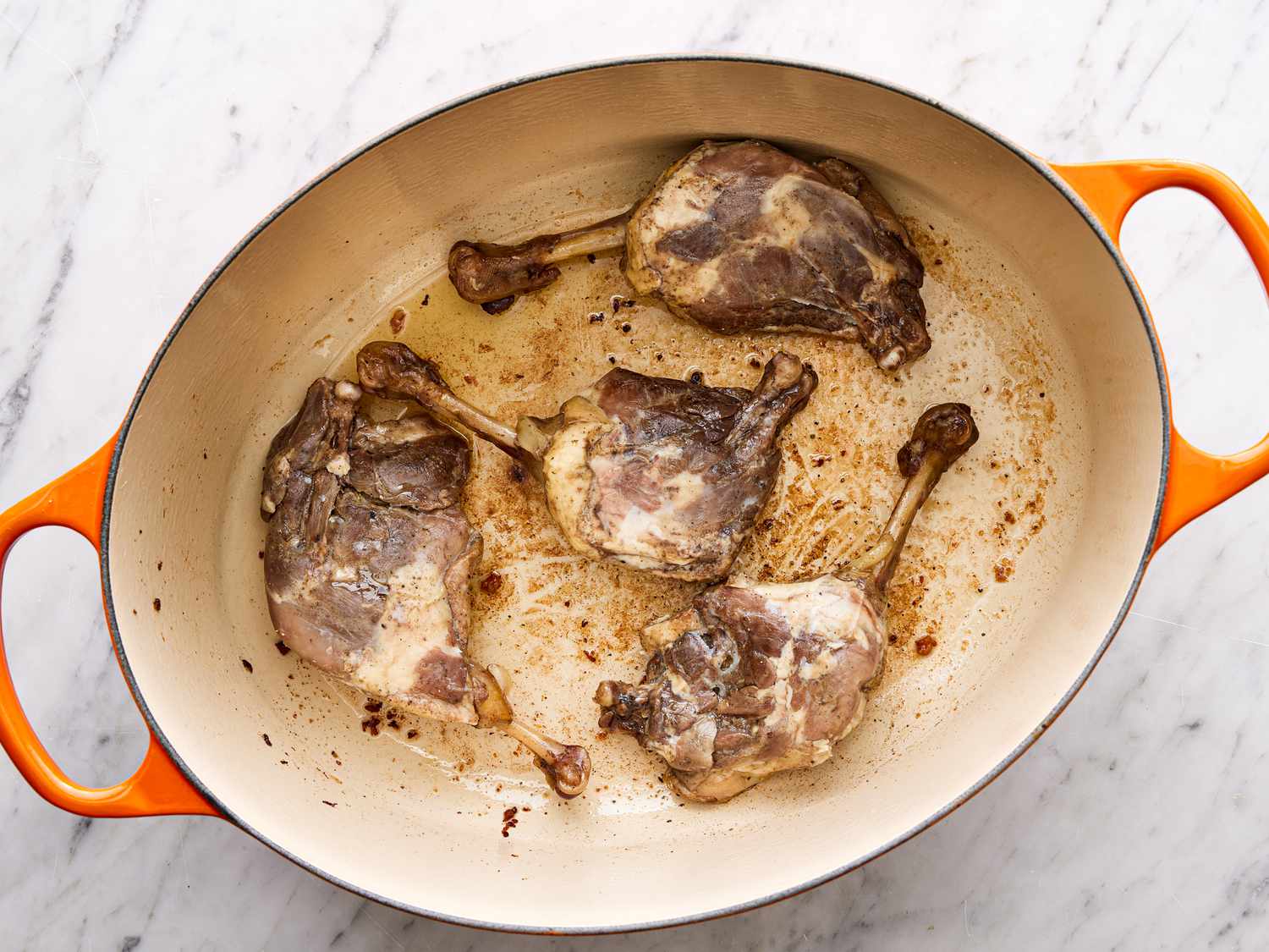 Meat placed skin-side down in Dutch oven.