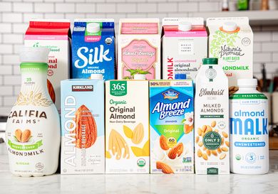 A variety of almond milk brands displayed on a counter