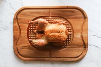 Fried Chicken placed on Lipper International Acacia Cutting Board with Grid Grip