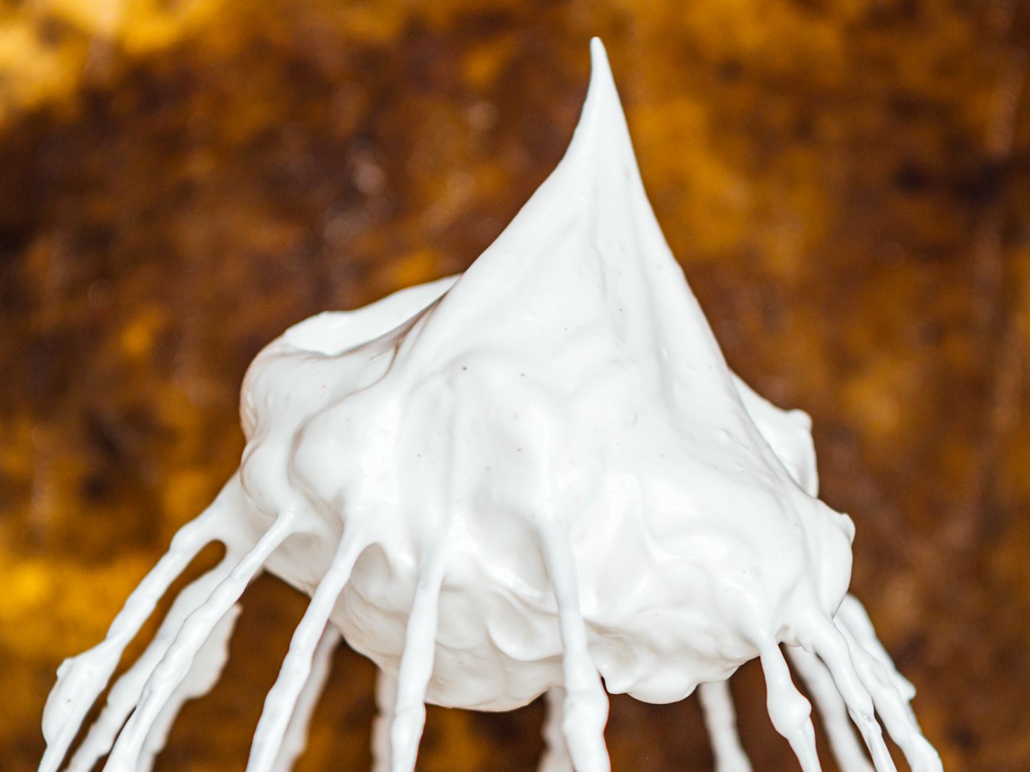 a whisk attachment showing stiff peaks 