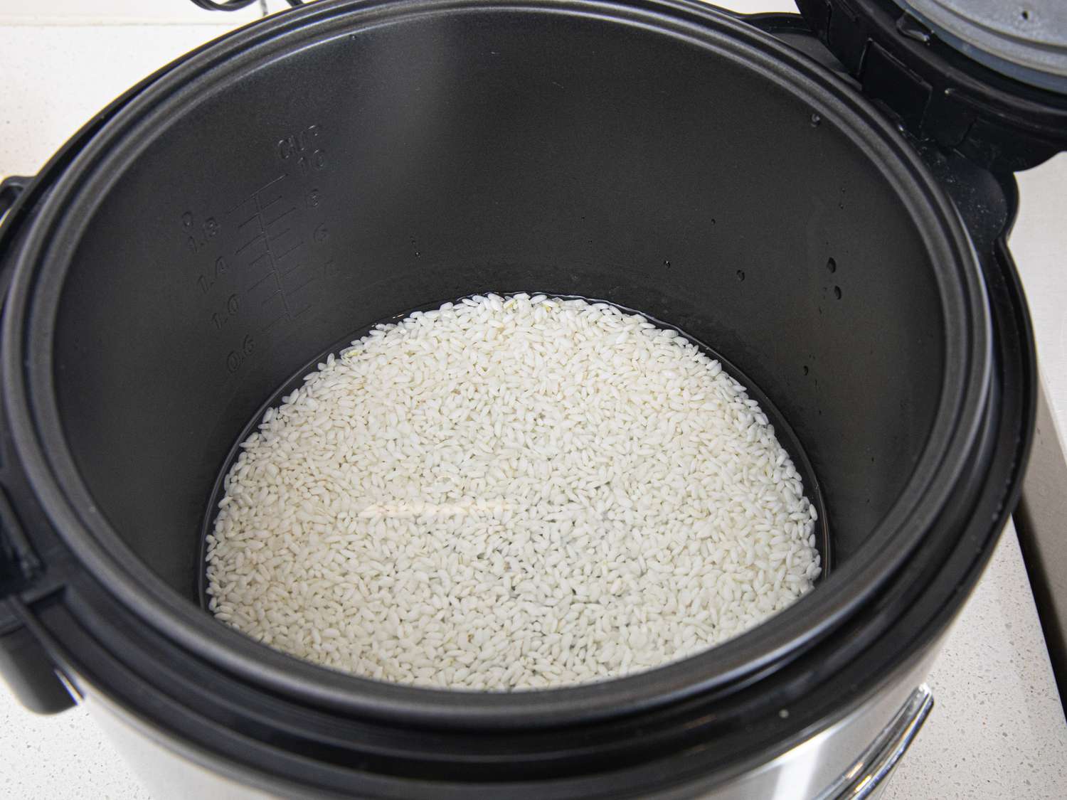 Overhead view of rice in a rice cooker