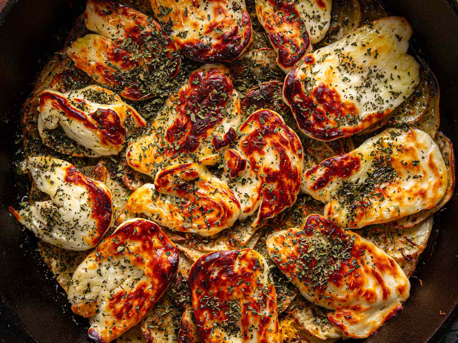 Cooked potato and halloumi gratin with herbs viewed from above