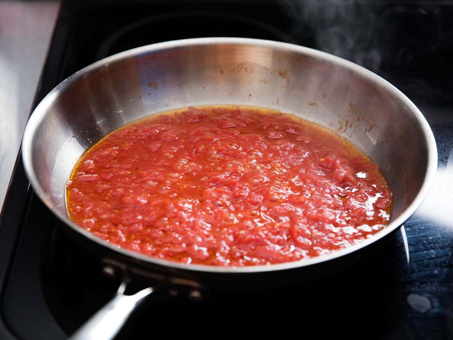 Red pasta sauce simmering in a skillet.