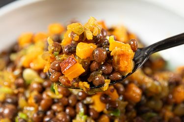 Close up of a spoon of pigeon peas and squash