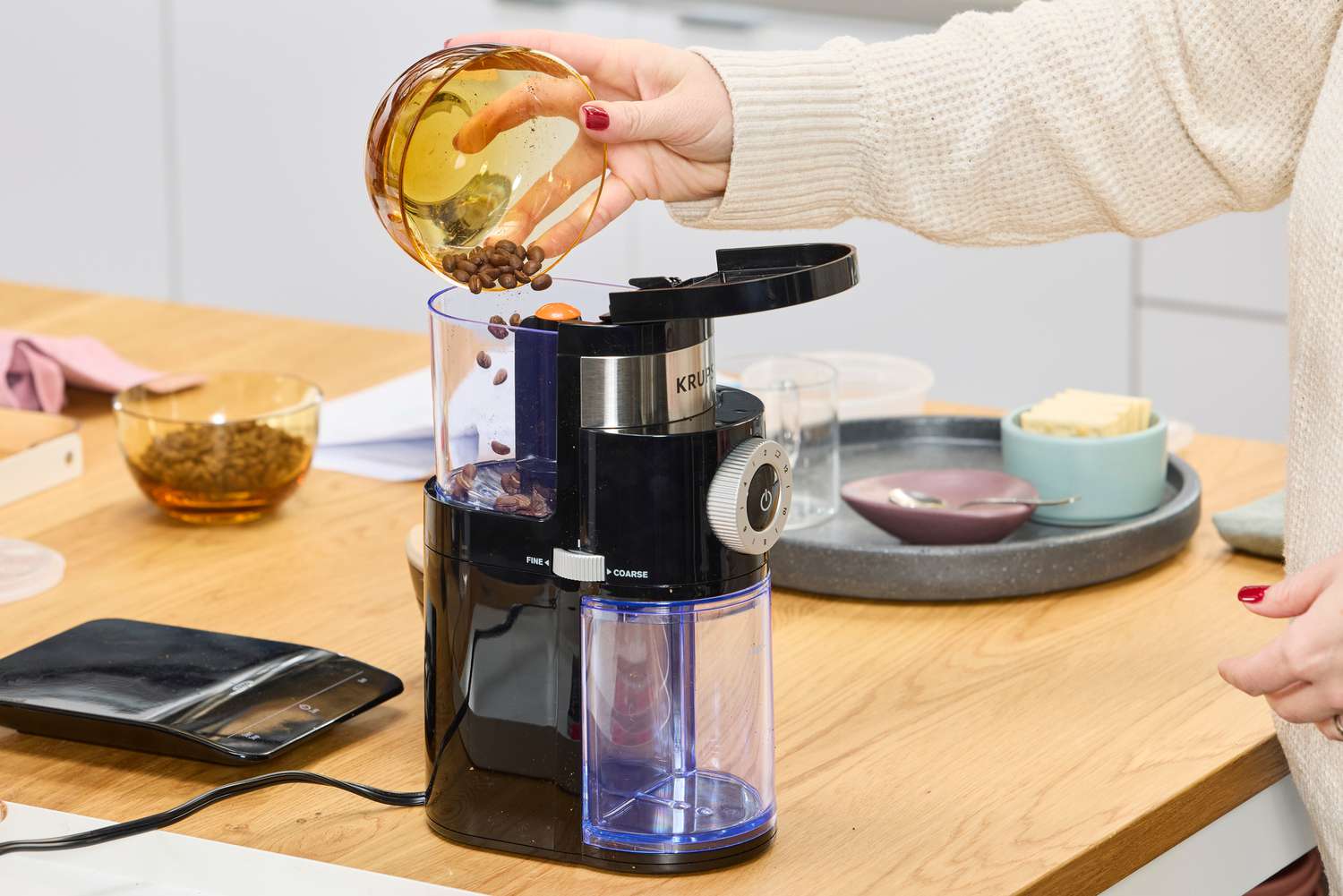 Person pouring coffee beans into Krups Precision Coffee Grinder