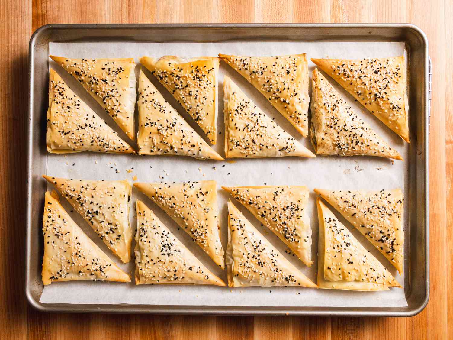 A baking sheet with 16 boreks after baking